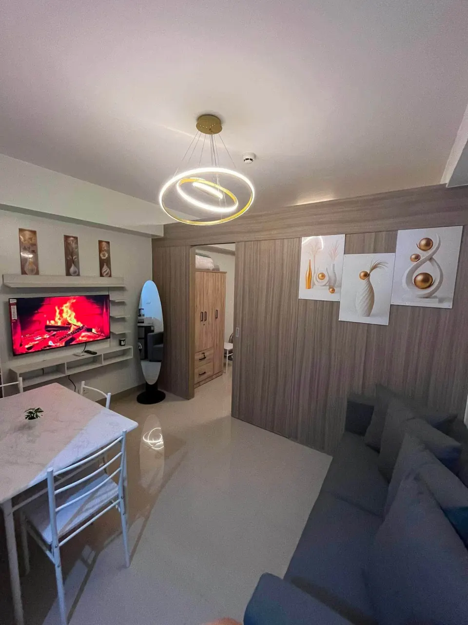 Living and dining area with a sofa, a dining table and a smart TV