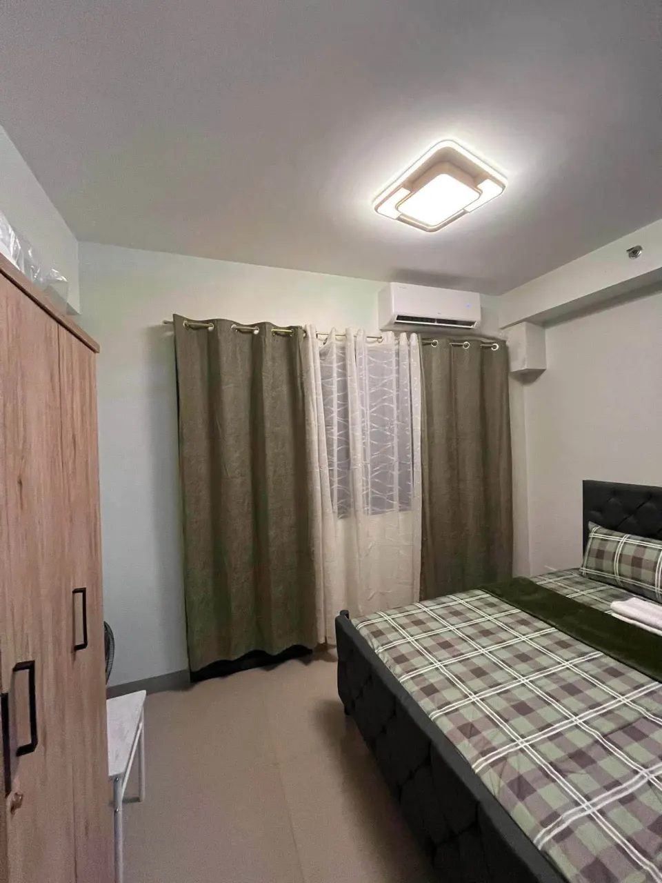Sleeping area with air conditioning and full-length curtains